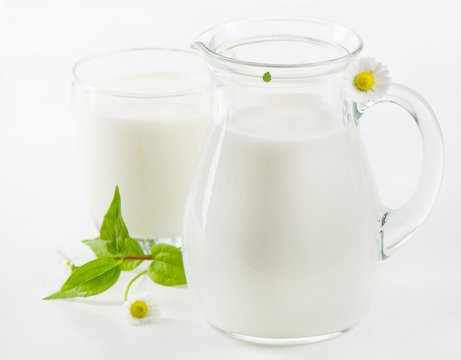 Glass jug and glass with milk