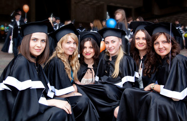 A group of girls in gowns of graduates