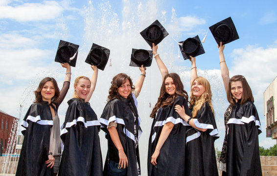 Graduates in robes near the fountain