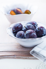Fresh plums in a bowl