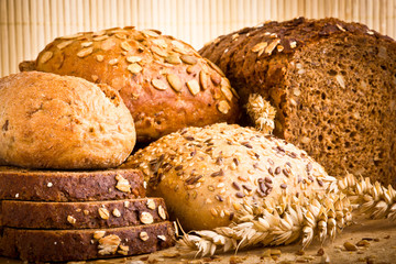 Collection of baked bread on wooden background