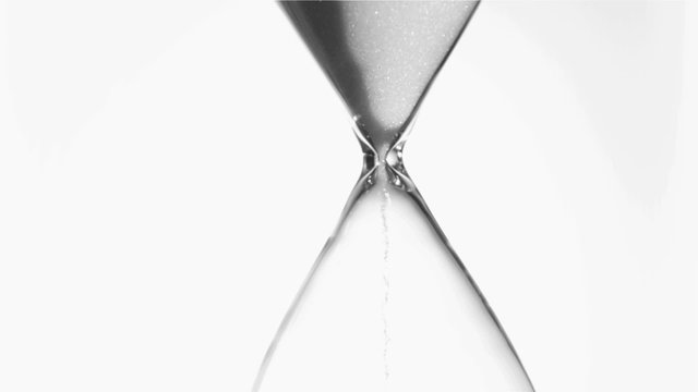 Sand flowing in super slow motion from an egg timer