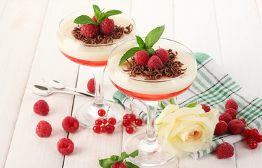 fruit jelly with berries in glasses on wooden table