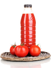 Tomato juice in bottle on wicker mat isolated on white