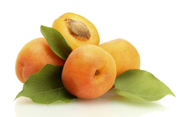 ripe sweet apricots with green leaves isolated on white