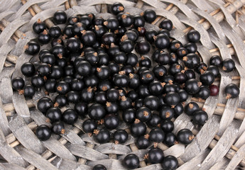 Black currant on wicker mat close-up