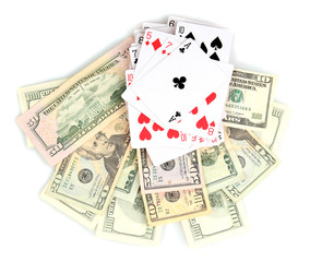 Dollars and a deck of playing cards isolated on white