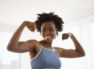 Black woman flexing biceps