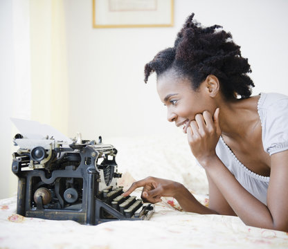 Black woman using old-fashioned typewriter