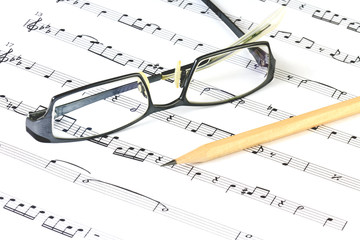 music sheet with pencil and glasses