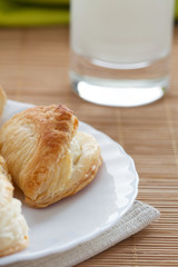 Puff pastry on the plate and glass with fresh milk