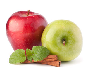 Red and green apples, cinnamon sticks and mint leaves still life