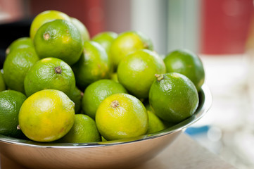 Fresh green limes in a bowl