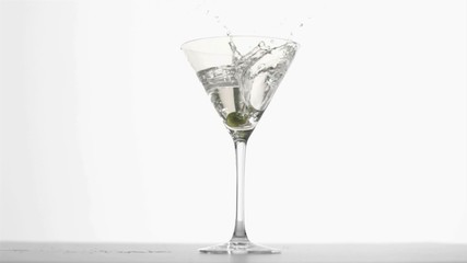 Olive diving in super slow motion in a martini - Powered by Adobe