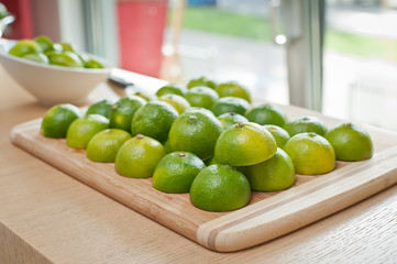 Fresh colorful, green limes limes on a tray