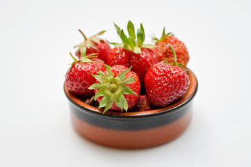Fresh strawberries in a bowl isolated on white