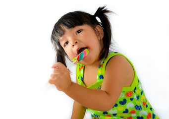 cute asian baby girl and big lollipop of thailand southeast asia