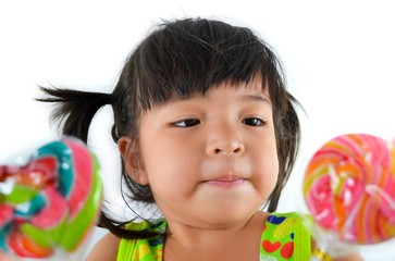 Fototapeta na wymiar cute asian baby girl and big lollipop of thailand southeast asia
