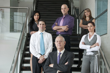 Hispanic business people standing together on staircase