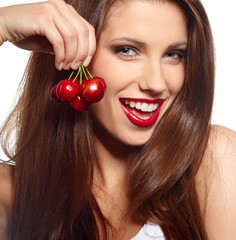 brunette holding cherryes, close up, looking at camera