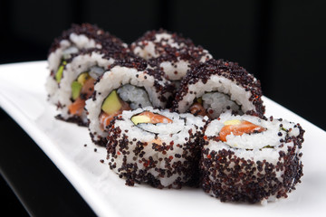 closeup image of a japanese sushi rolls on a white plate