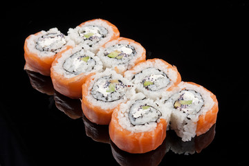 closeup image of a Sushi Roll on black background