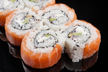 closeup image of a Sushi Roll on black background