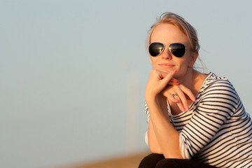 Fototapeta premium Beautiful girl is looking at the sunset