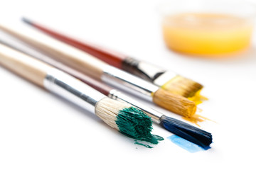 Fototapeta premium Set of brushes stained with paint near the ink container