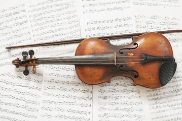 an old violin with a bow on the background music