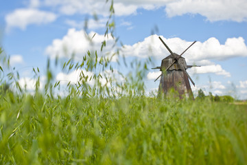 old mill in an oat field