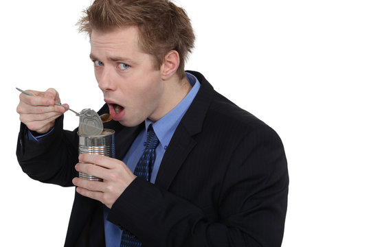 Man Eating Dog Food In A Tin Can