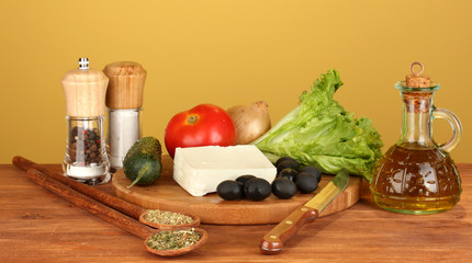 Ingredients for a Greek salad on brown background close-up