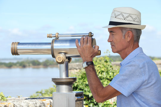 Man Using A Telescope