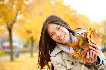 Fall woman playing with leaves