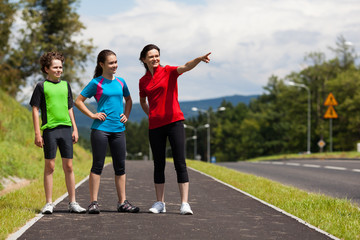 Active family - mother and kids exercising outdoor