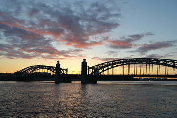 Fototapeta na wymiar Neva rzeki i Most Piotra Wielkiego na zachodzie słońca
