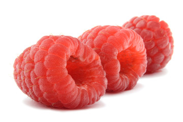 Three raspberries isolated over white background