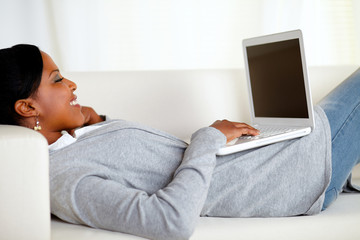 Young relaxed woman working on laptop
