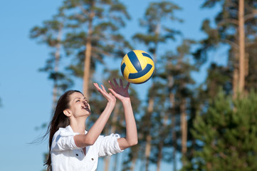 Woman playing volleyball on beach