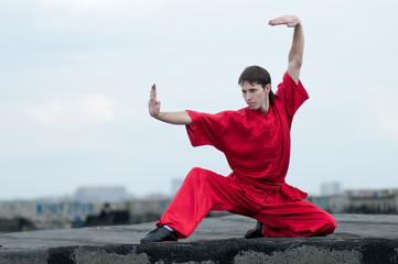 Fototapeta na wymiar Wushoo man in red practice martial art