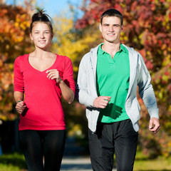 Young man and woman running