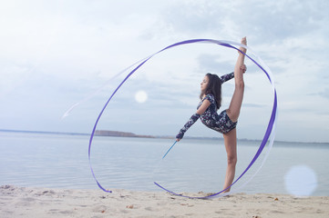 Young gymnast girl dance with ribbon