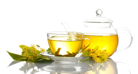 cup and teapot of linden tea and flowers isolated on white