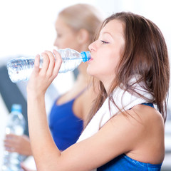 Women drinking water after sports
