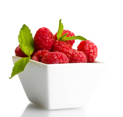 ripe raspberries with mint in bowl isolated on white