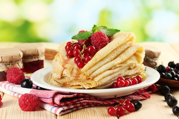 pancakes with berries, jam and honey