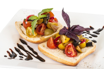 juicy tomatoes on fresh bread, pesto as topping