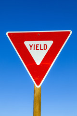 yield Sign at the highway with blue sky