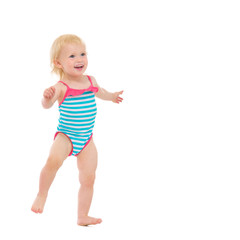 Smiling baby in swimsuit dancing